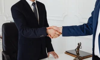two men in suits shaking hands