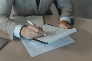 Businessman signing document with pen