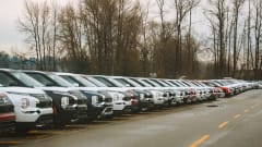 Line of eclipse SUVs in parking lot.