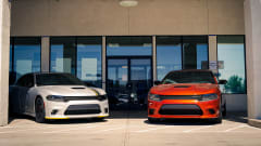 Two dodge cars outside of dealership.
