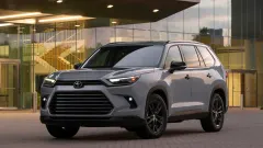 Gray Toyota SUV parked outside of glass paned building