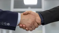 Two white men's shaking hands
