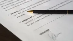 Insurance contract signature page with black inkpen on top