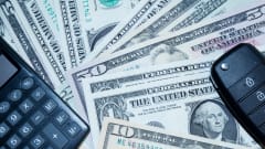 Paper money, car key fob and calculator