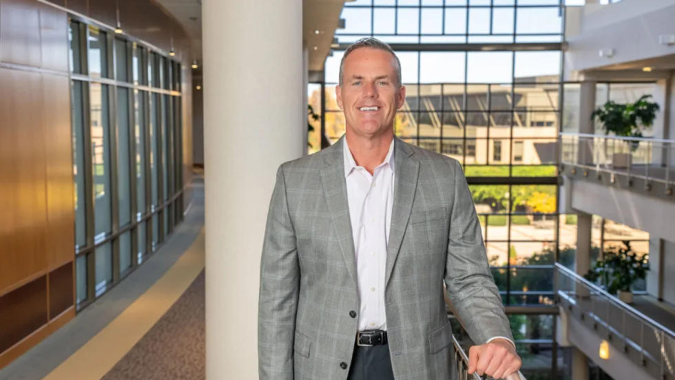 Shawn Concannon, president of TSD Mobility Solutions, stands inside a modern office building, representing TSD’s continued growth in connected-fleet technology.