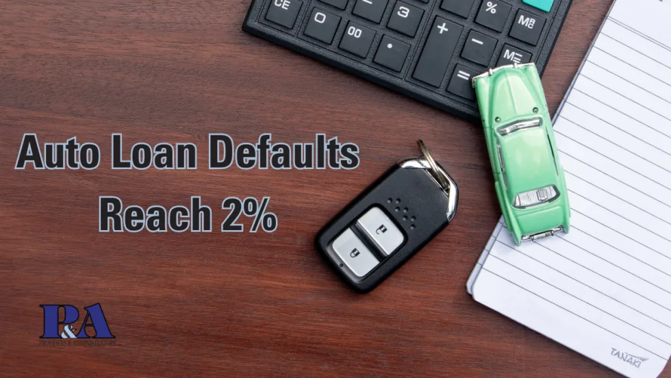 text reading Auto Loan Defaults Reach 2% on desk background with car keys, calculator, notepad, and toy car