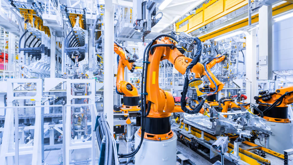 inside of automotive manufacturing plant, robotic assembly