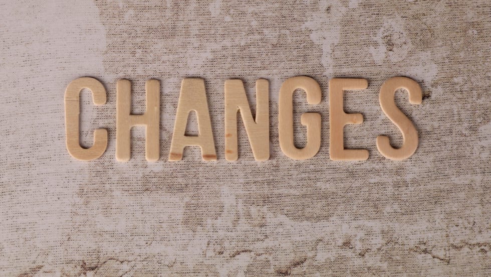 'CHANGES' spelled out in two-dimensional letters on a concrete-like surface