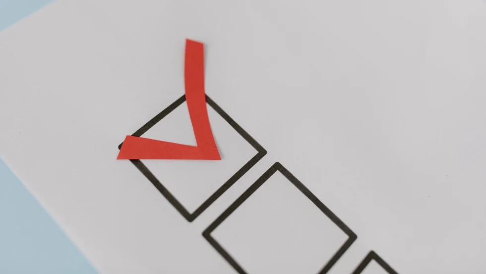 A checkbox on a sheet of paper checked in red
