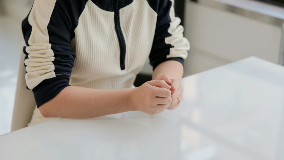 Woman in casual clothing sitting at a desk