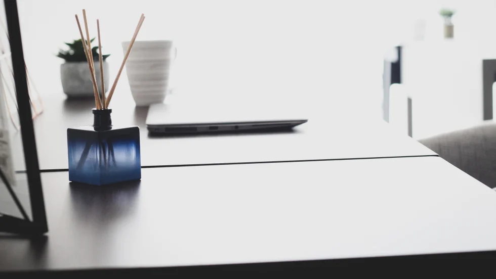 Photo of essential oil diffuser on desk next to laptop