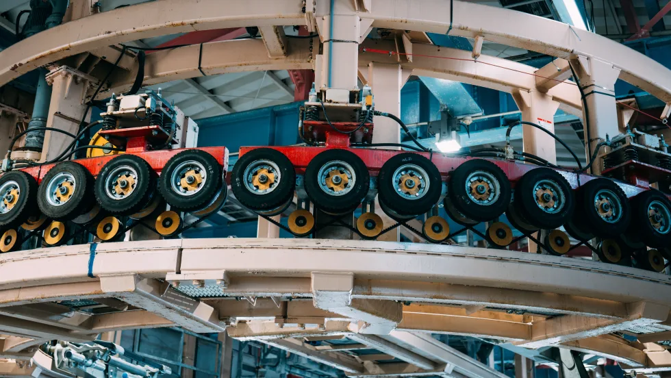Tires hung up on wall in factory.