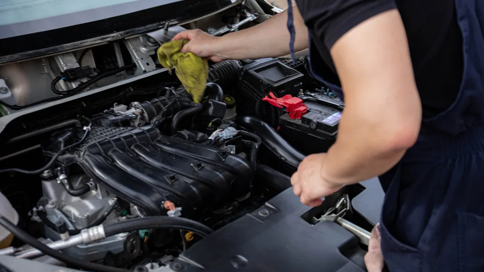 Mechanic cleaning interior of engine