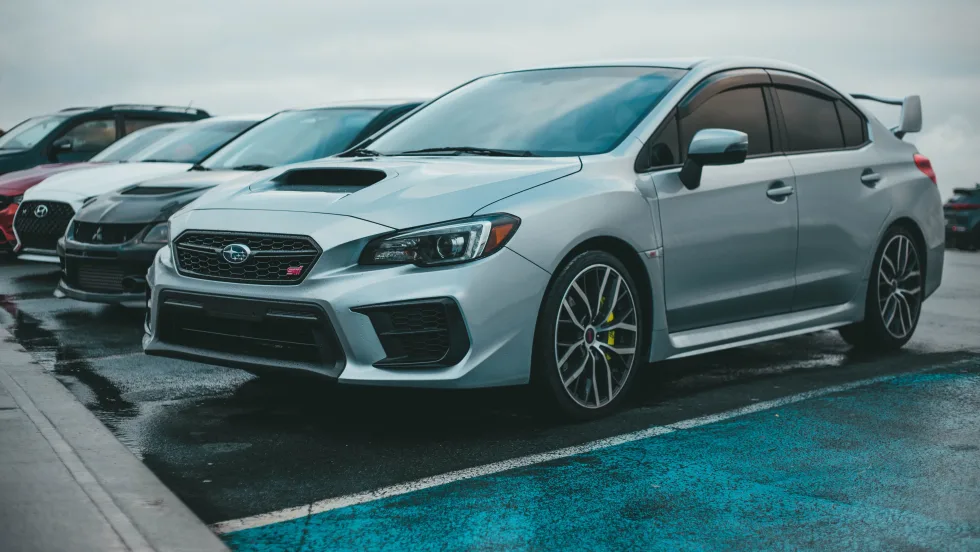 Silver Subaru STI parked in lot.