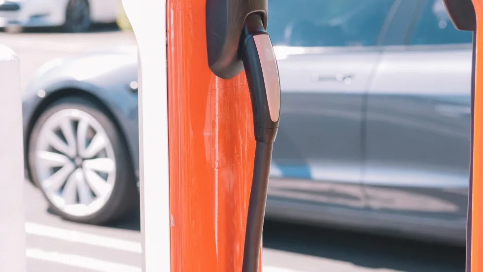 Orange electric vehicle charging station.