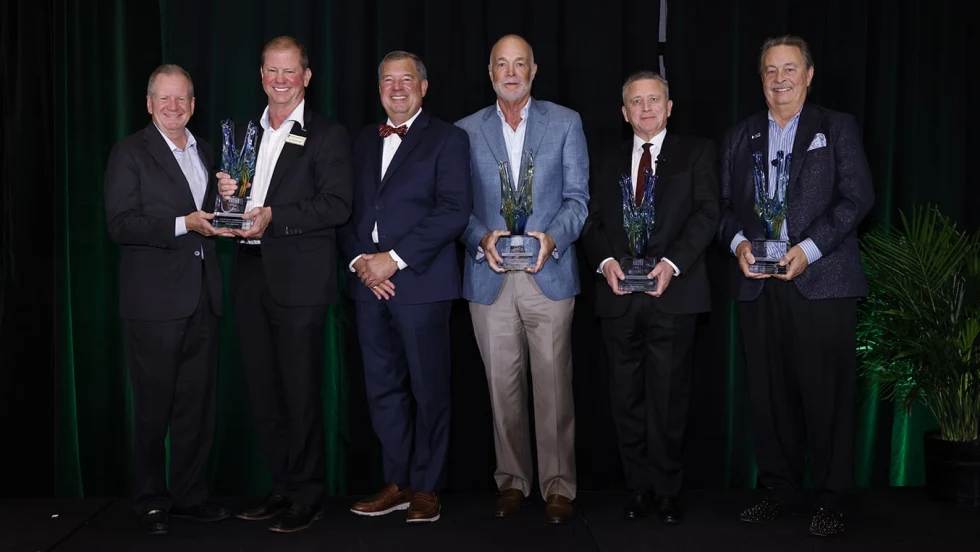 Group photo of men holding awards.