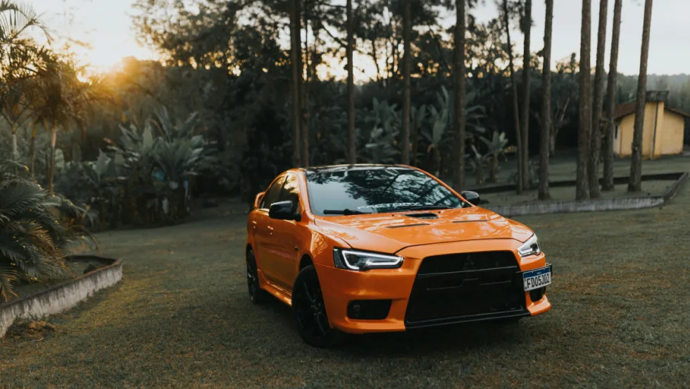 Orange Mitsubishi car on grass
