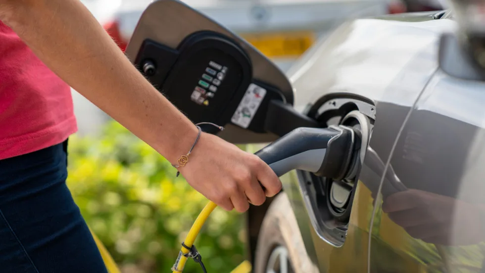 Person pumping gas into car.