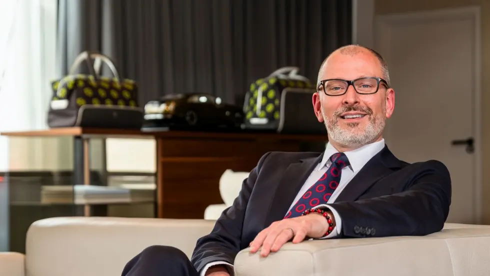 Man in suit and glasses smiling for photo
