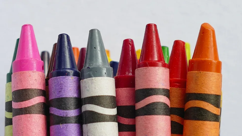Handful of colorful crayons.