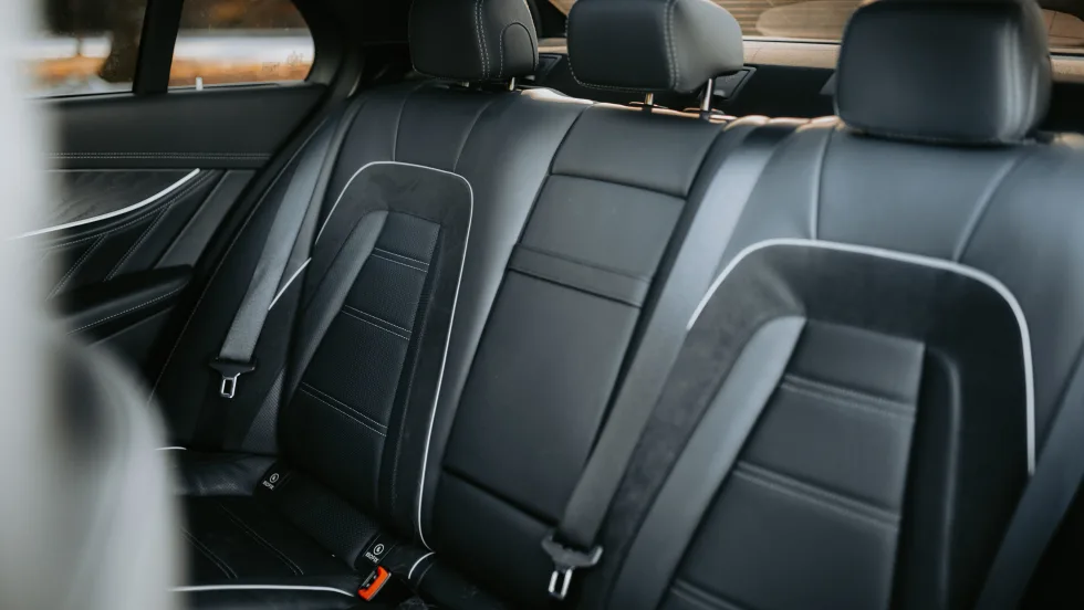 Black leather with white trim back passenger seats.