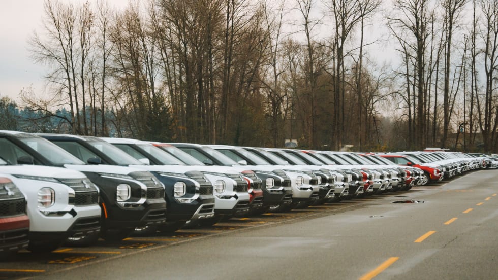 Line of eclipse SUVs in parking lot.