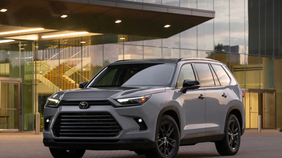 Gray Toyota SUV parked outside of glass paned building