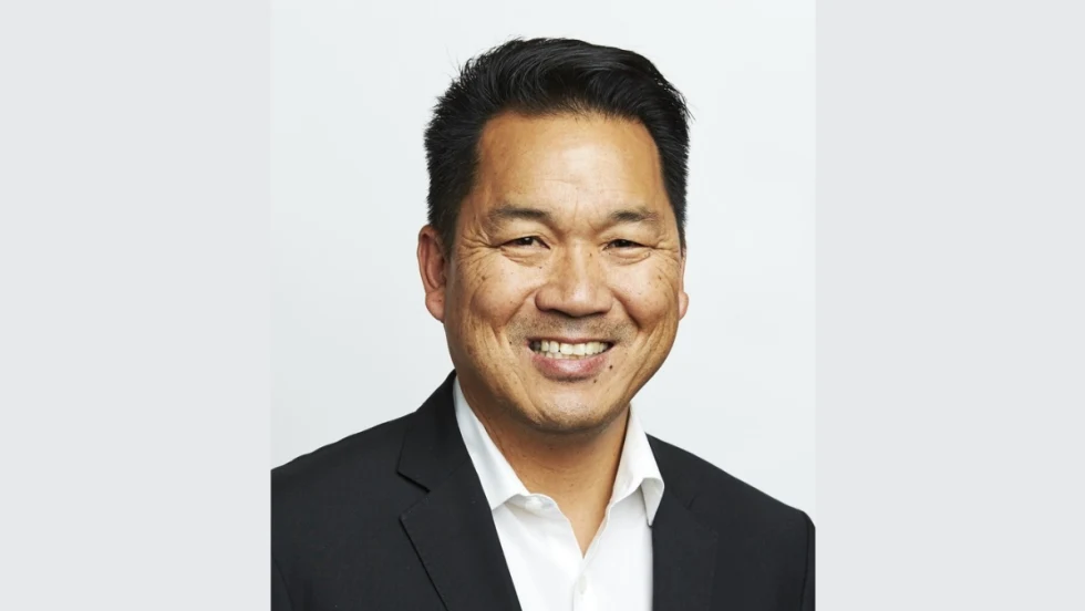 Asian man in black suit with white collared shirt