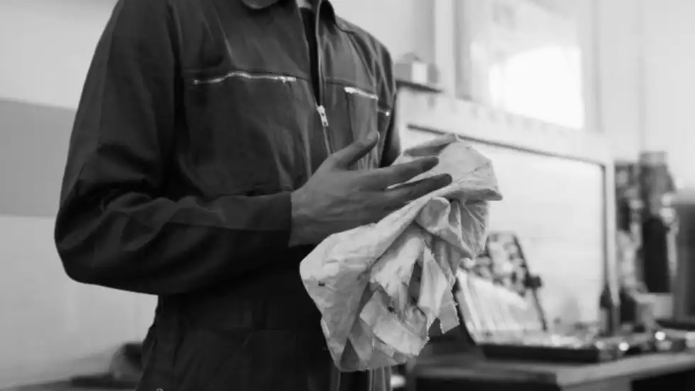 Photo of mechanic wiping his hands on a rag