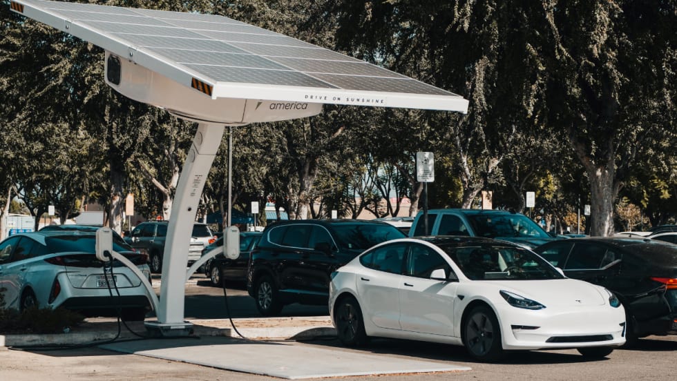 white electric car charging at an outside port