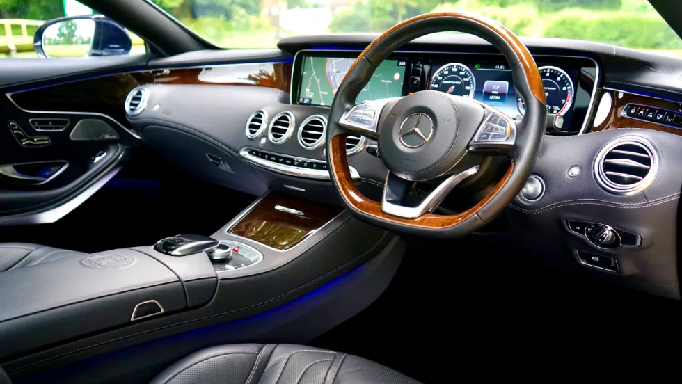 interior view of car dashboard and steering column. gray interior 