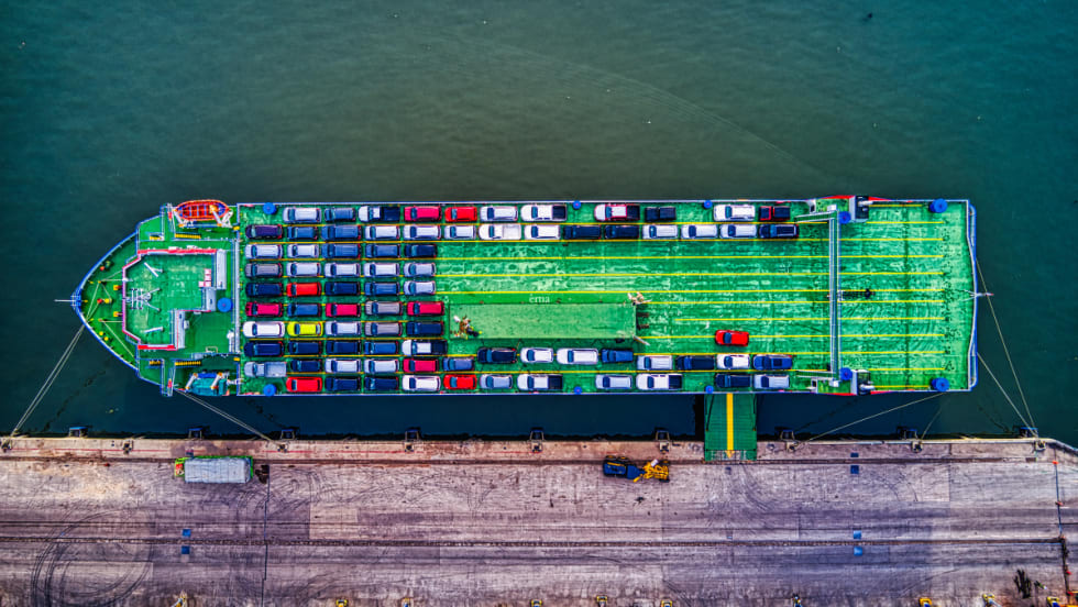 cargo ship with vehicles, at dock