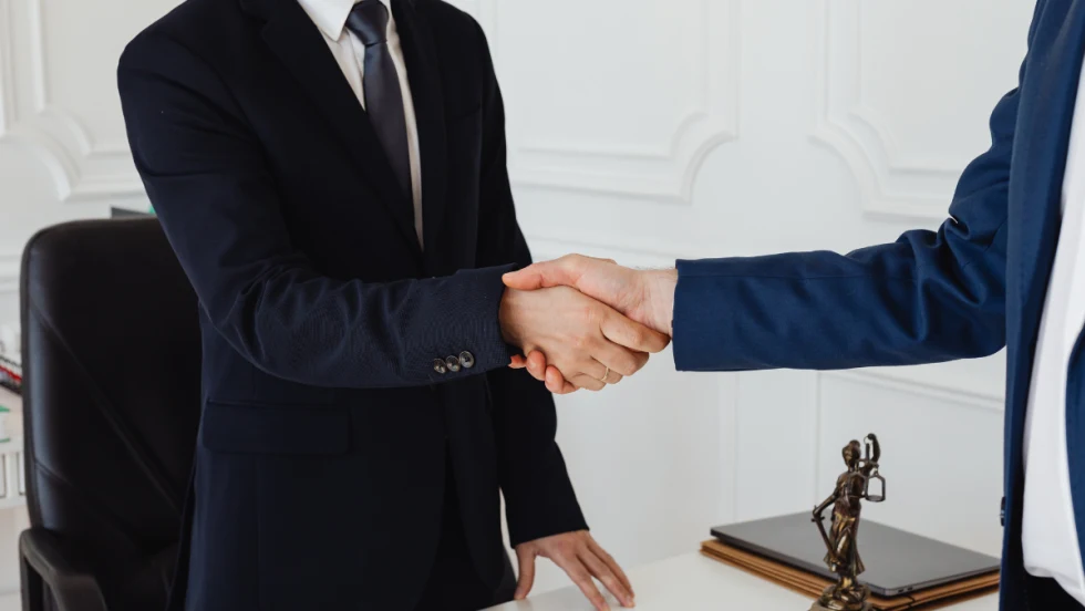 two men in suits shaking hands