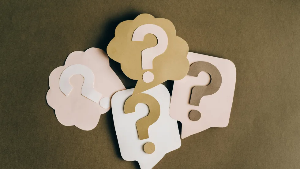Several illustrations of question marks on a surface