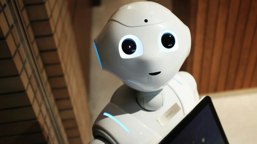 Photo of robot holding a laptop