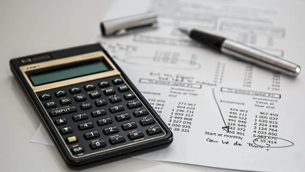 Photo of document next to calculator and inkpen