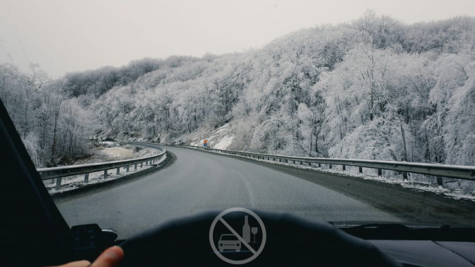 car driving down snowy road