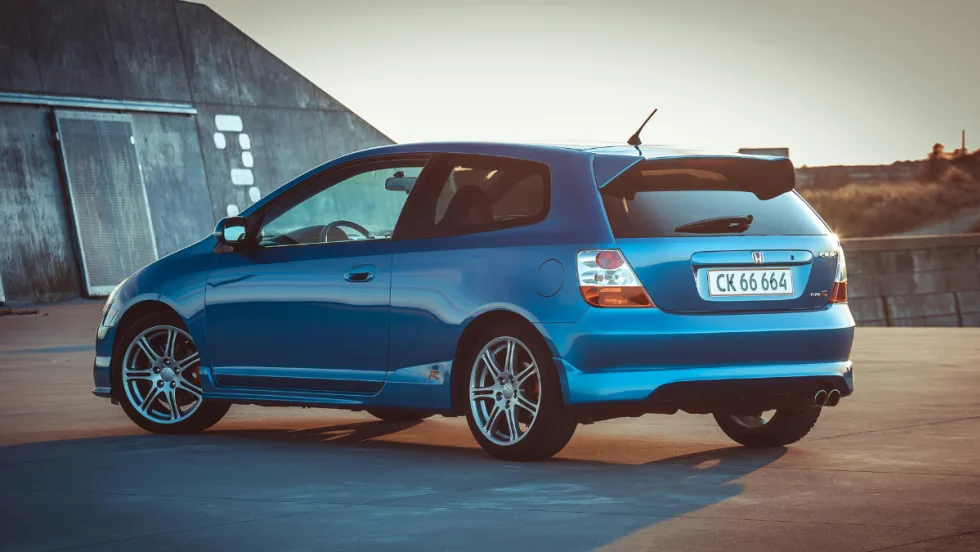 blue Honda hatchback outside