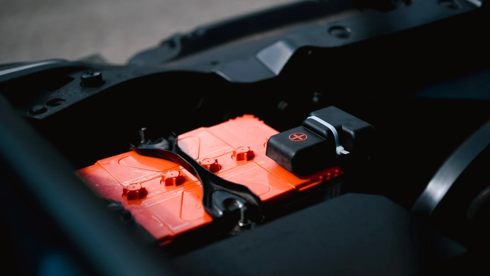 Closeup photo of an orange car battery