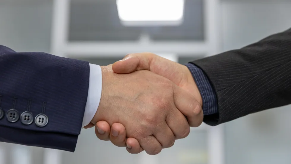 Two white men's shaking hands
