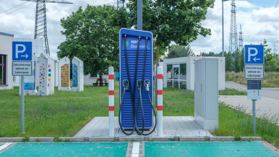 public electric vehicle charging station with one charger and two parking spots
