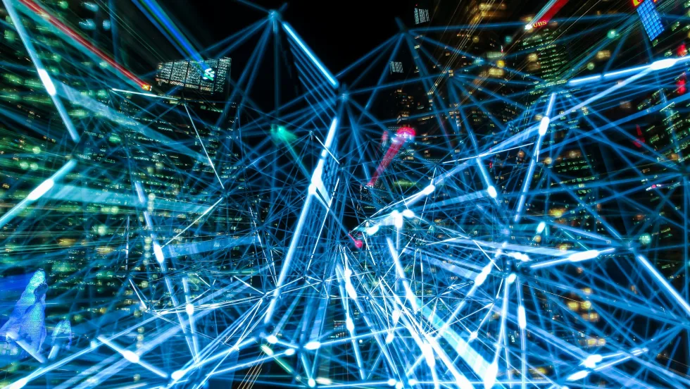 LIght trails with nighttime cityscape in background