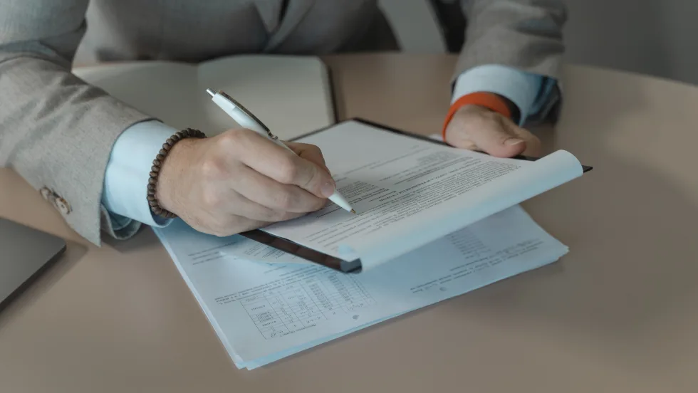 Businessman signing document with pen