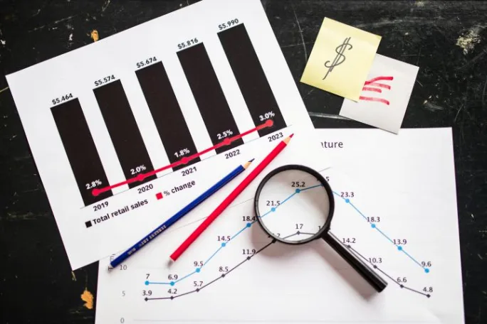 Photo of two charts with magnifying glass