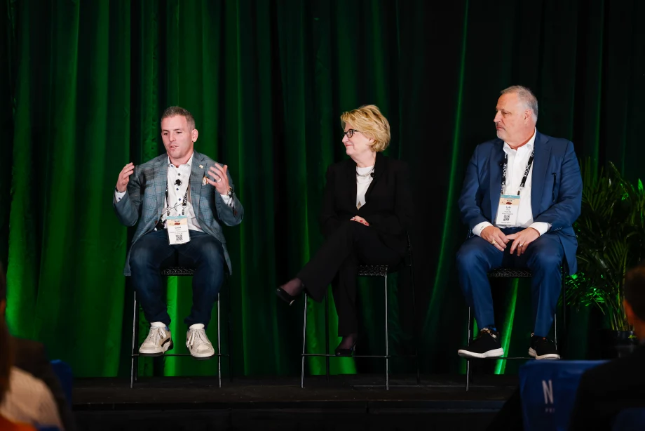 Photo of two men and one woman on a discussion panel
