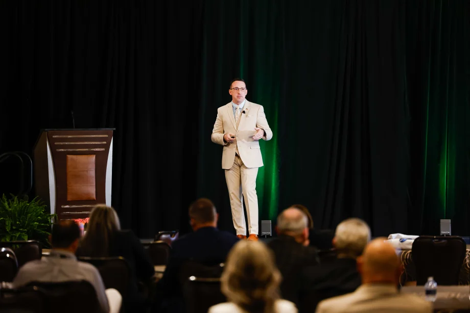 Dustin Gingerich standing on stage giving a presentation