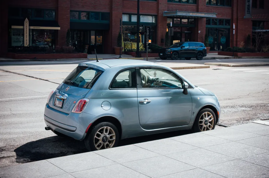 Light-blue Fiat car parked on a sunny Chicago street