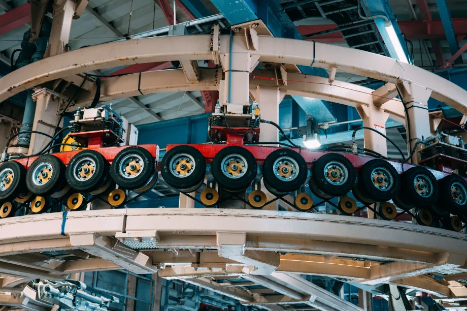 Tires hung up on wall in factory.