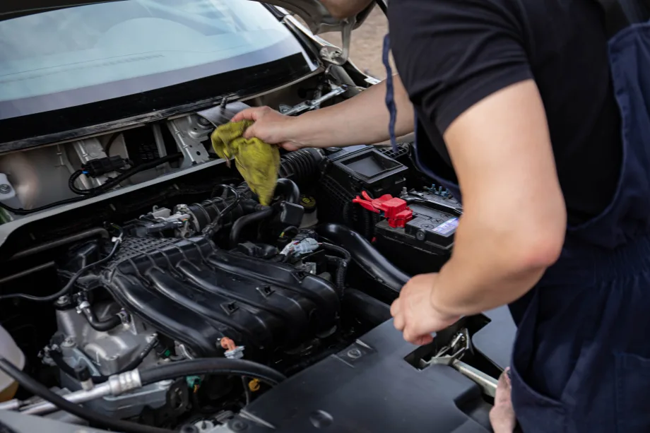 Mechanic cleaning interior of engine