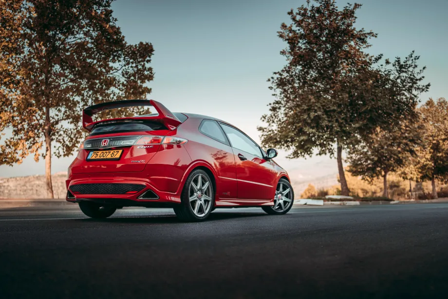 Red type R Honda civic parked on road.